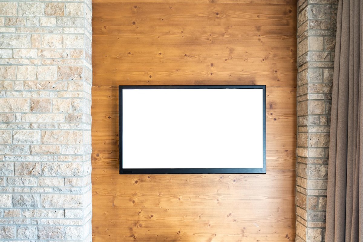 A flat-screen television mounted on a timber-clad wall.