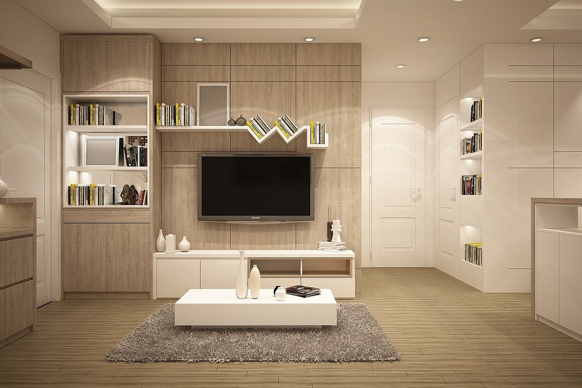 A living room with a wall-mounted television above a low media unit.