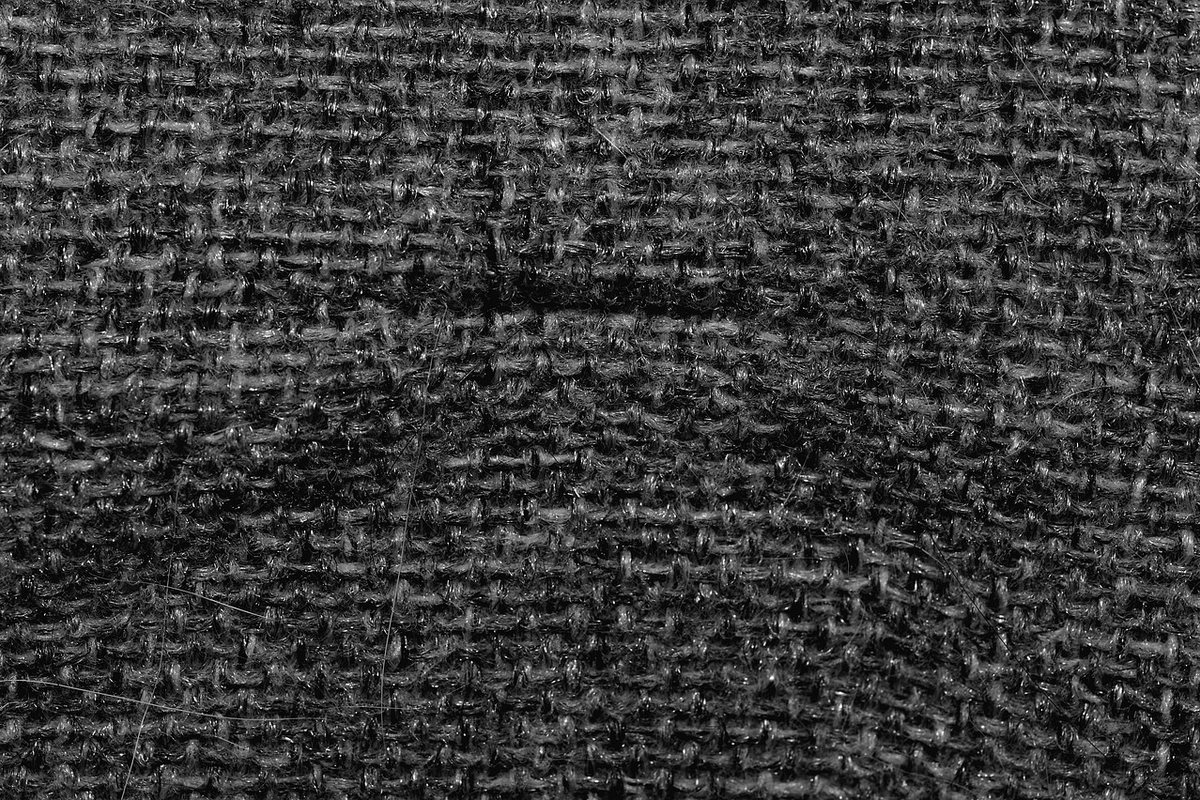 A close-up of dark grey woven upholstery fabric.